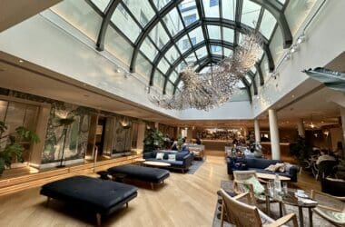 a room with a large glass ceiling and a large chandelier