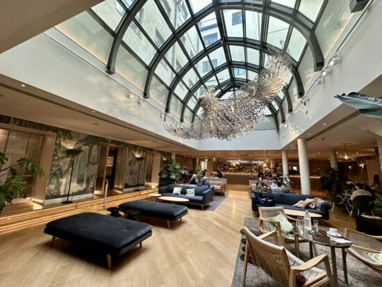 a room with a large glass ceiling and a large chandelier