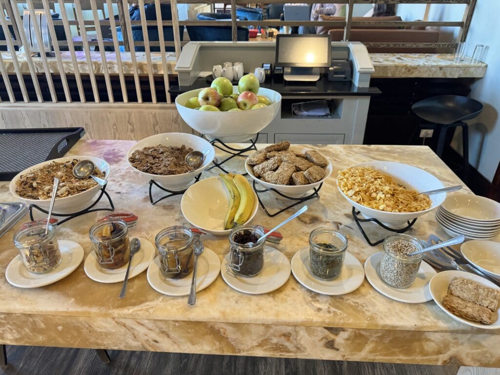 a table with bowls of food and fruits