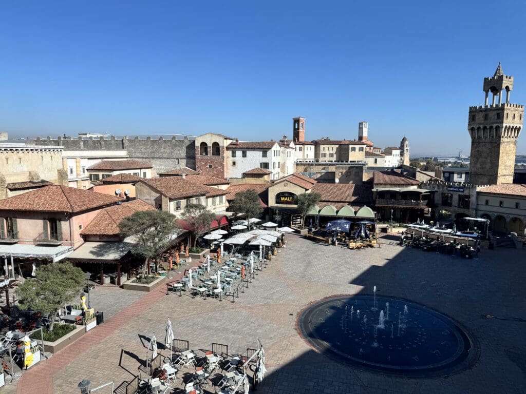 a courtyard with a fountain in the middle of a town