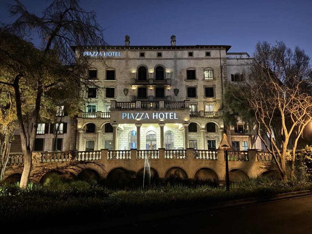 a building with a bridge and trees