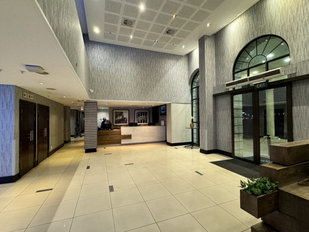 a lobby with a reception desk and a glass door