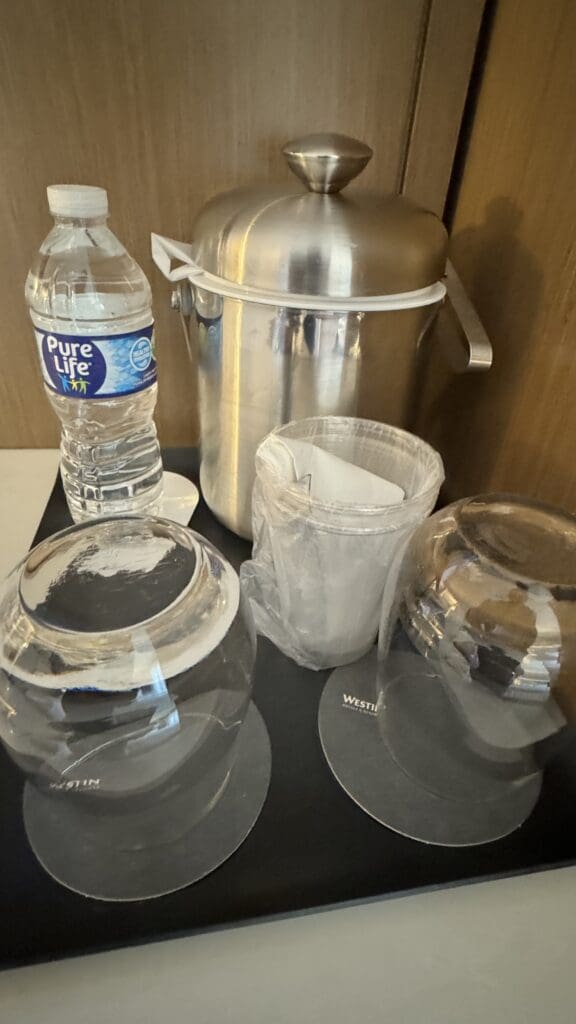 a group of glasses and a bottle of water