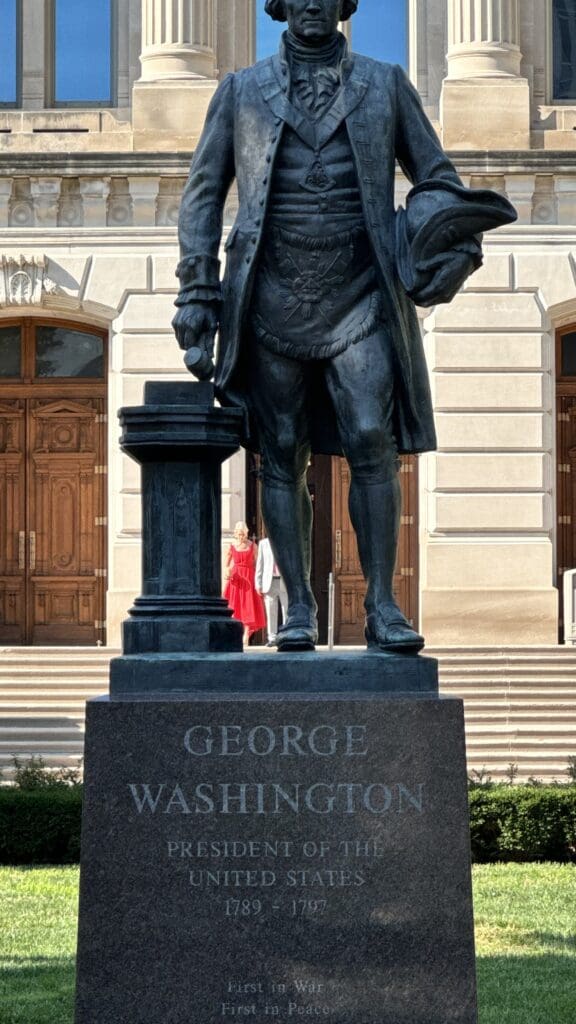 a statue of a man in front of a building