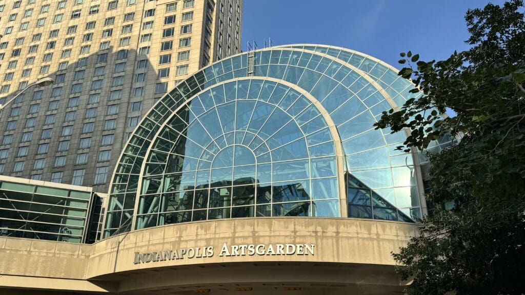 a glass dome with a building in the background