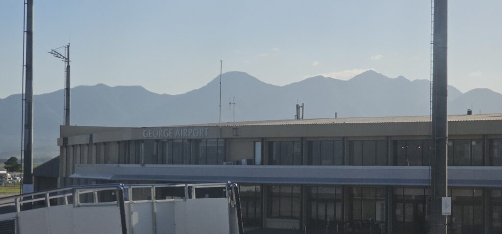 a building with mountains in the background