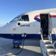 a man standing in the door of an airplane