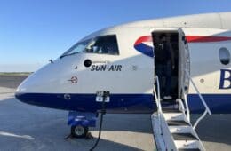 a man standing in the door of an airplane