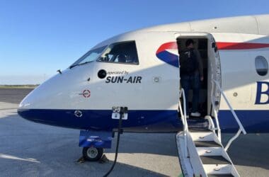 a man standing in the door of an airplane