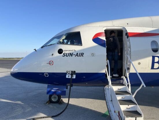 a man standing in the door of an airplane