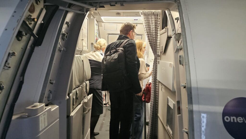 a group of people standing in an airplane