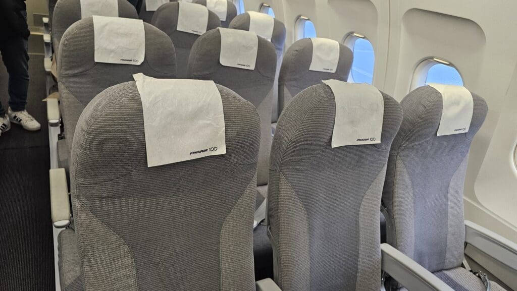 a row of seats with white paper on them