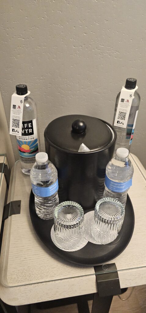 a group of water bottles and glasses on a table