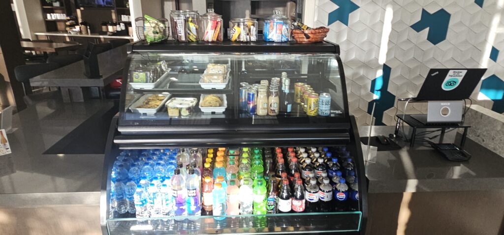 a display case with drinks and food on top