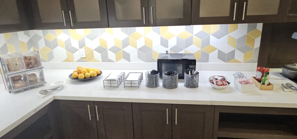 a kitchen counter with a microwave and fruit bowl