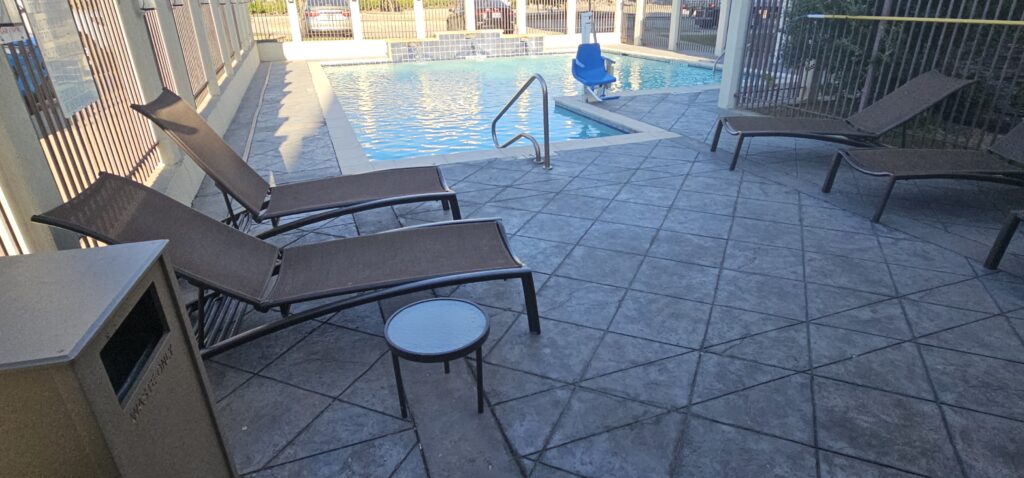 a pool with chairs and a chair in the back