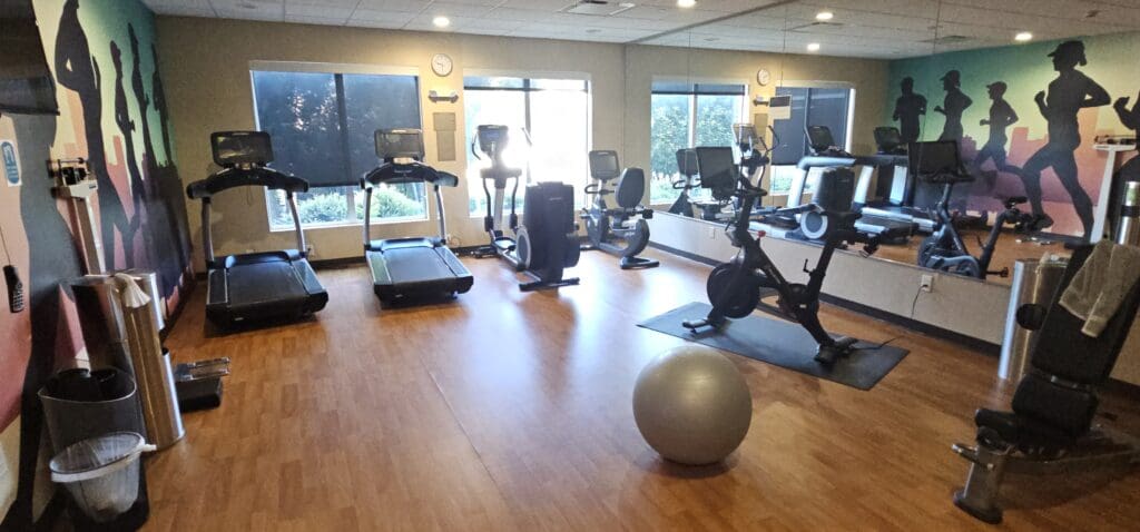 a room with exercise equipment and a ball