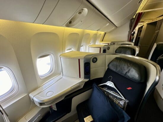 a seat in a plane in Air France 777 Business Class