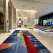 a large hall with colorful rugs