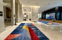 a large hall with colorful rugs