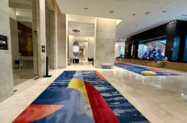 a large hall with colorful rugs