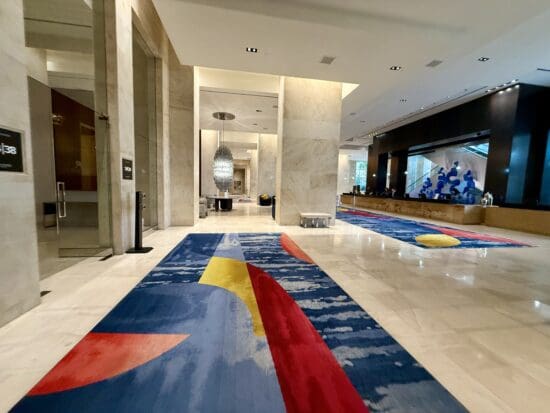 a large hall with colorful rugs