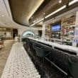 a bar with a counter and chairs