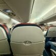 a group of people sitting in an Delta E175 Comfort Plus