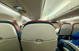 a group of people sitting in an Delta E175 Comfort Plus