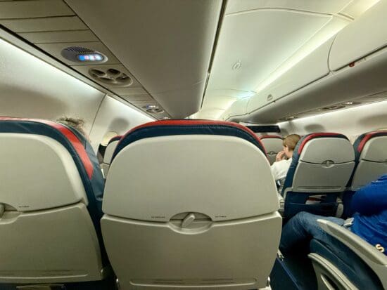 a group of people sitting in an Delta E175 Comfort Plus