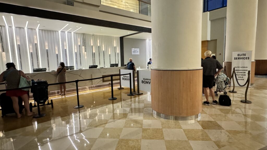 a group of people standing in front of a reception desk