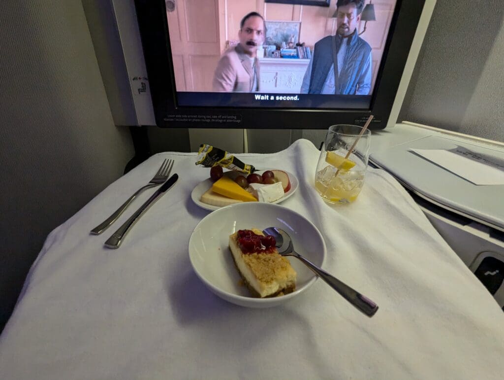 a plate of food on a table with a television