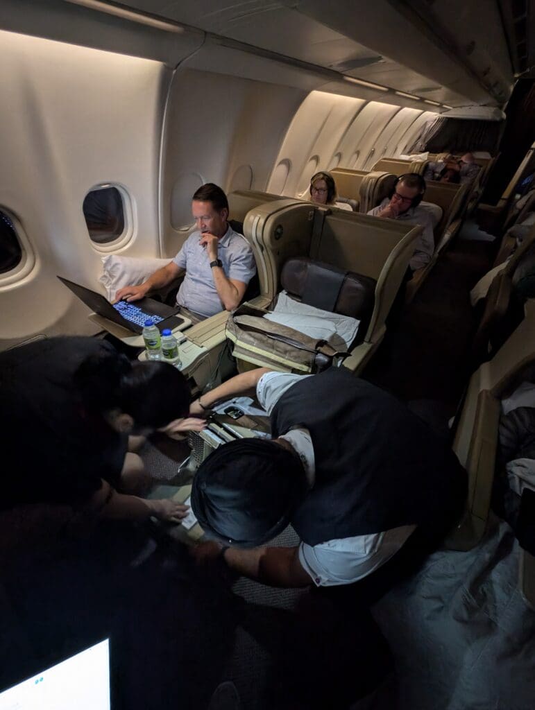 people sitting in an airplane with people on their lap