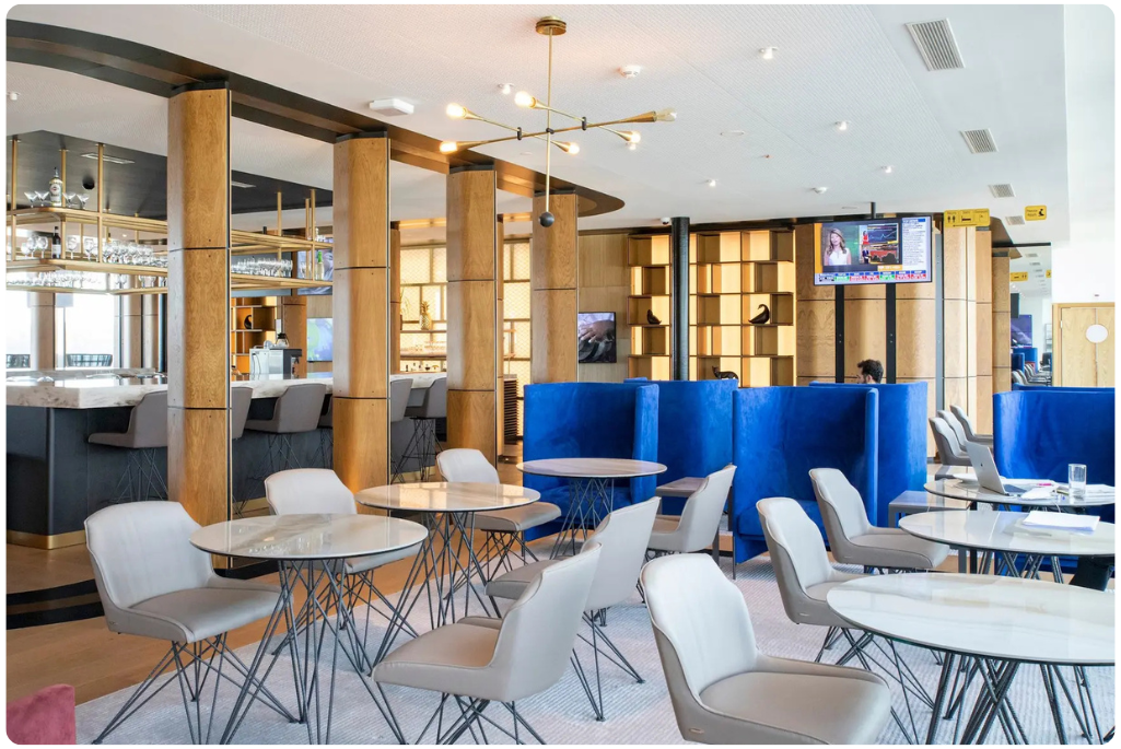 An airport lounge at Zurich Airport featuring restaurant style seating and a bar