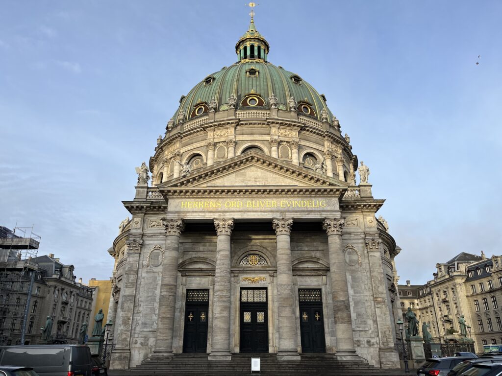 a large stone building with a green dome