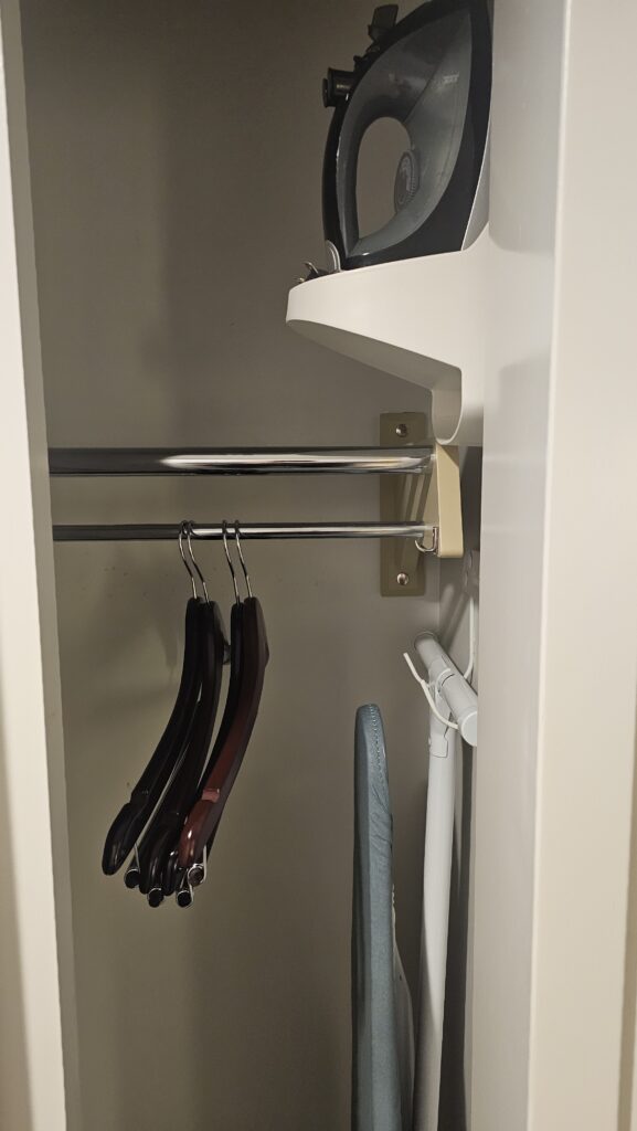 a closet with clothes on a rail