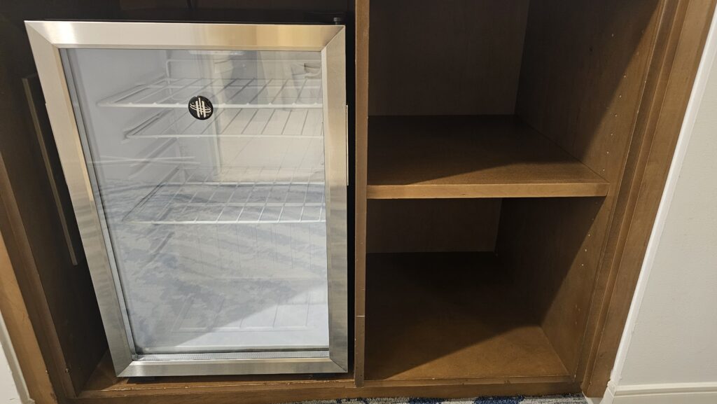 a refrigerator and shelves on a shelf