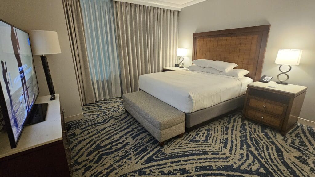 a bed with a bench in a hotel room