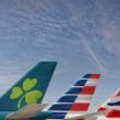 tail tails of airplanes with a clover and a flag