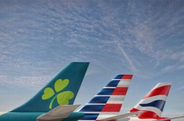 tail tails of airplanes with a clover and a flag