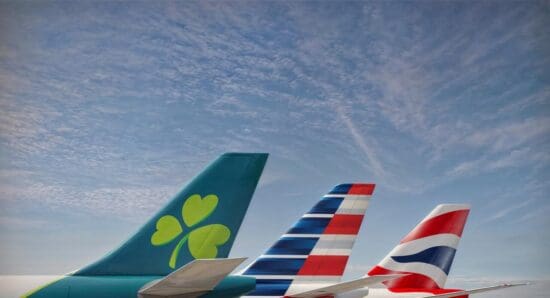 tail tails of airplanes with a clover and a flag