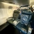 a group of people sitting in the United Embraer 170 First Class Cabin