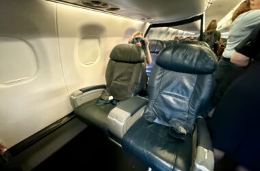 a group of people sitting in the United Embraer 170 First Class Cabin