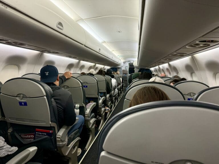 a group of people sitting in United Embraer 170 Economy Class