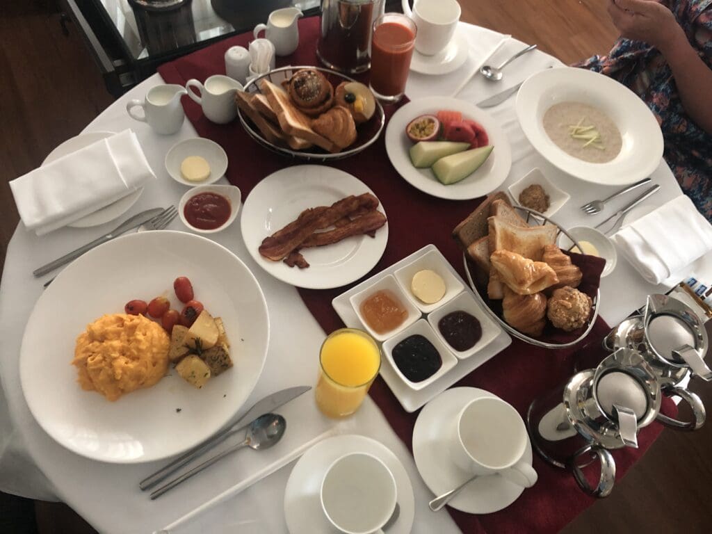 a table with plates of food and drinks