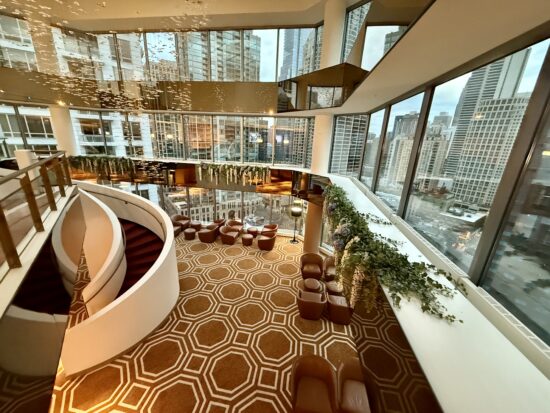 a large room with a staircase and a large window at the Residence Inn by Marriott