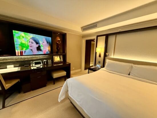 a room with a large television and a bed at the Peninsula Chicago