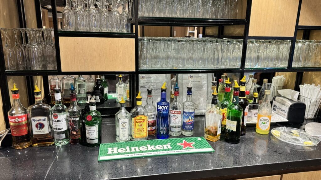 a shelf with bottles and glasses on it