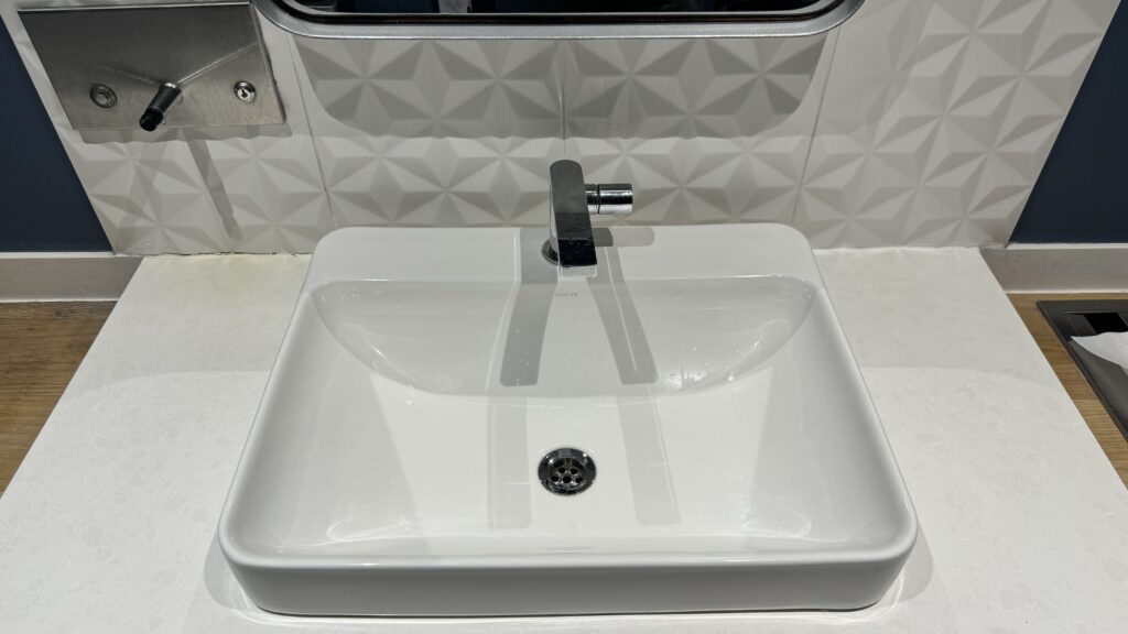 a white sink with a faucet