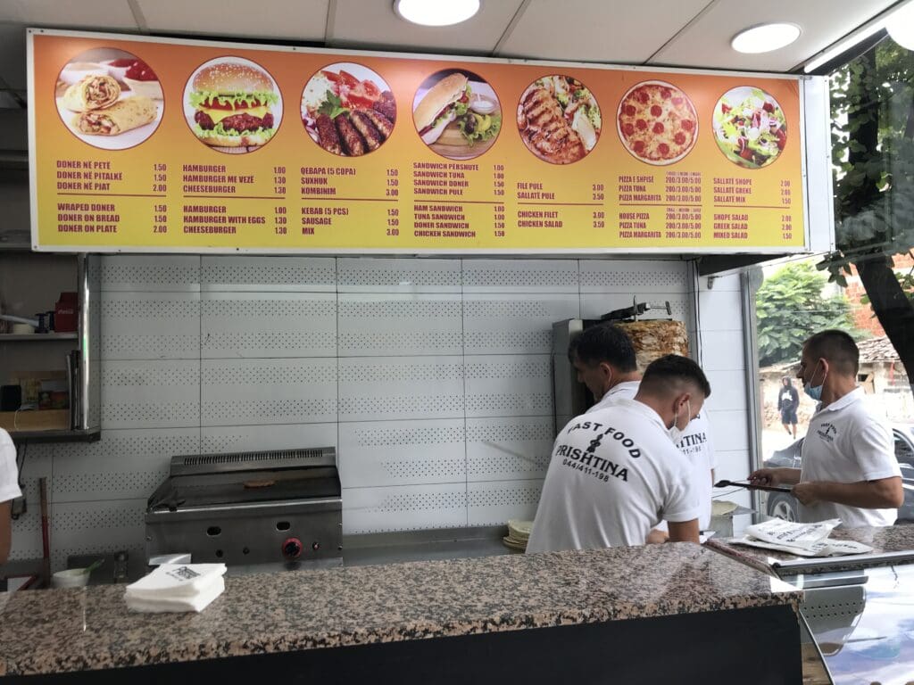 a group of men standing behind a counter